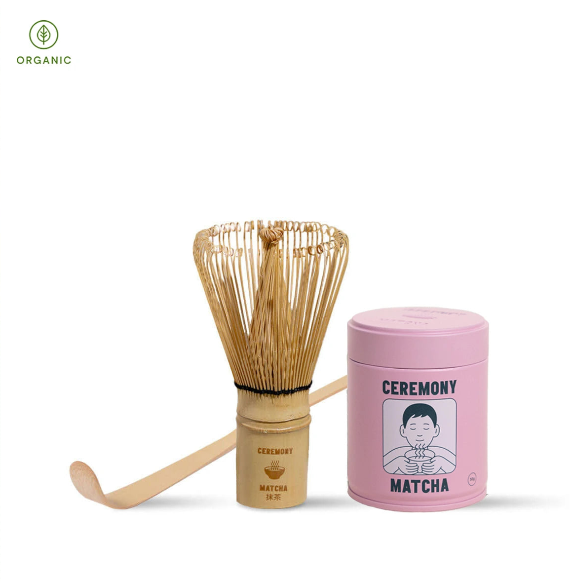 Matcha preparation set with wooden whisk, container, and pink lid on a white background