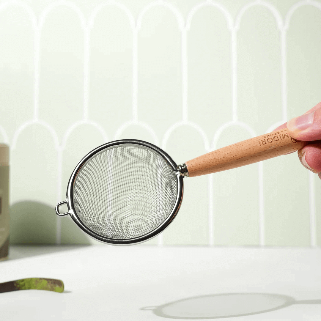 Ceremonial Matcha Starter Bundle by Midori Spring with 100g Emerald Matcha, 80-prong gold bamboo whisk, purple bamboo scoop, and wooden-handled sifter for authentic matcha preparation.