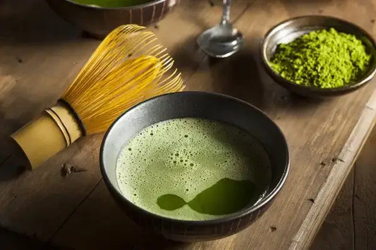 Traditional bowl of matcha tea with a whisk, representing the history of matcha tea in Japan.