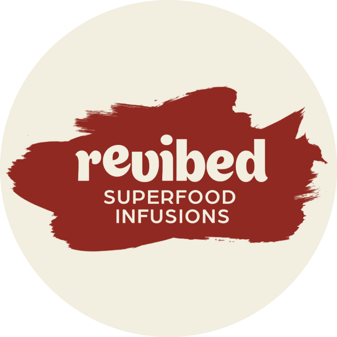 Revibed Drinks logo featuring "superfood infusions" text with a red paintbrush design on a round beige background.