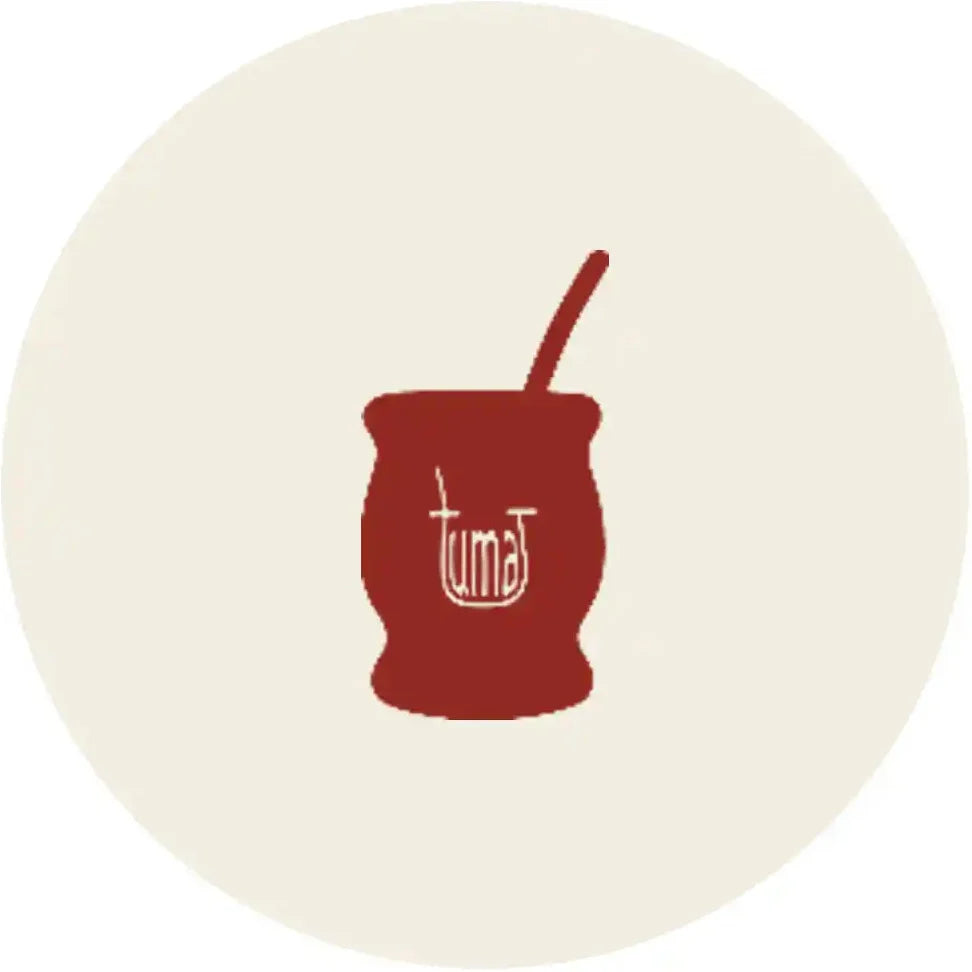 A minimalist illustration of a red mate cup with a white spoon and the word 'tumat' on the front, centered inside a large cream circle on a white background.