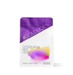 Costa Rica Red Honey Specialty Coffee in purple and white bag with gold text, featuring grape and honey notes on the packaging.