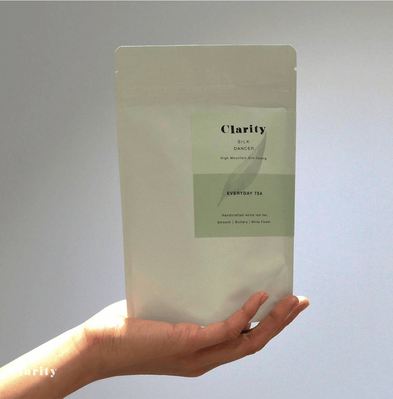 Clarity Silk Dancer Milk Oolong tea with smooth, floral, and milky notes, crafted in Taiwan from the Golden Lily cultivar by an award-winning tea master.