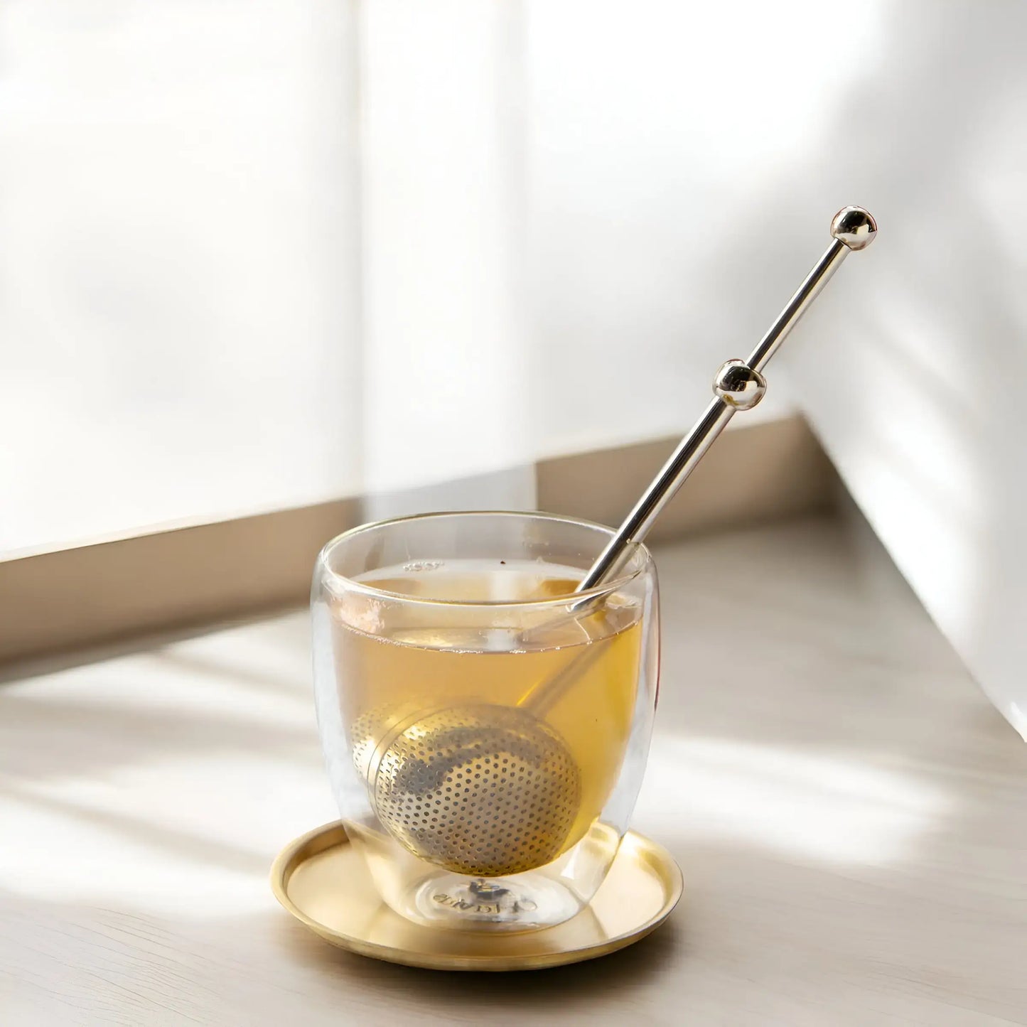 Elegant gold modern fine mesh tea infuser for precise and flavorful loose-leaf tea brewing.