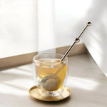 Elegant gold modern fine mesh tea infuser for precise and flavorful loose-leaf tea brewing.