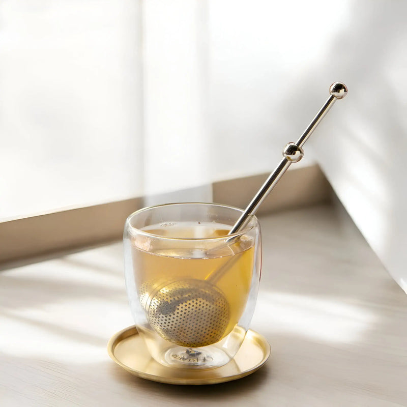 Elegant gold modern fine mesh tea infuser for precise and flavorful loose-leaf tea brewing.