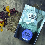 Fruity Yerba Mate Patagonia blend 150g with vibrant fruit aromas and traditional yerba mate on a rustic backdrop.