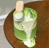 PerfectTed vanilla matcha latte topped with creamy foam, matcha powder and a vanilla biscuit garnish