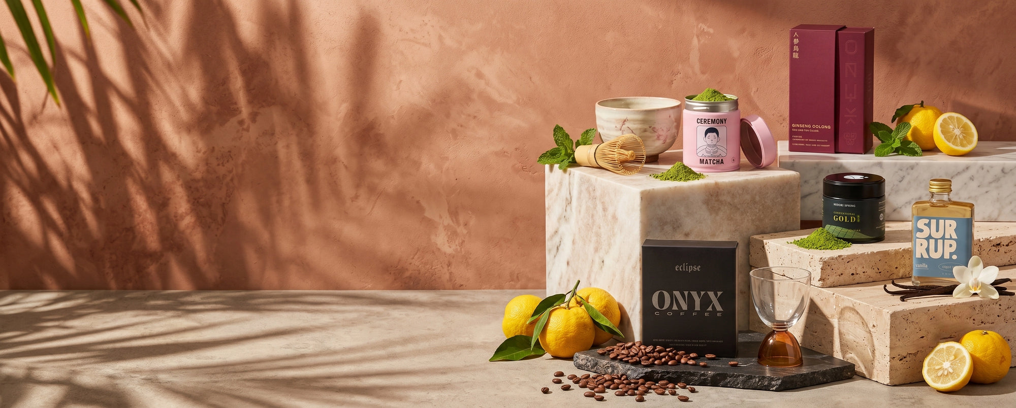 Product display with a pink mug, lemon slices, and other items on a stone surface against a brown wall.