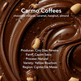 A close-up chocolate swirl background with text reading 'Carmo Coffees' and flavor notes 'chocolate mousse, caramel, hazelnut, almond.' Additional text lists producer, farm, process, variety, and region, with the 'biru' logo at the bottom.