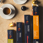 Colombian Decaf Specialty Coffee Capsules alongside other Flava coffee boxes on a marble background.