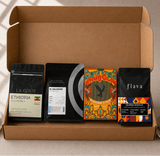 Open cardboard box containing coffee packages with visible branding and labels.