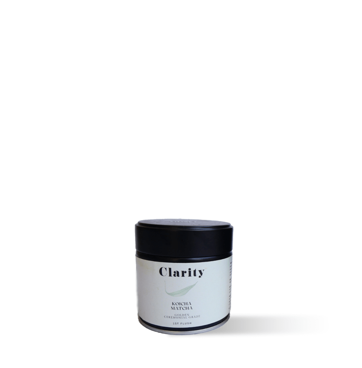Clarity Koicha matcha green tea powder in a double-walled glass bowl beside a ceremonial matcha tin, smooth and vibrant in color.