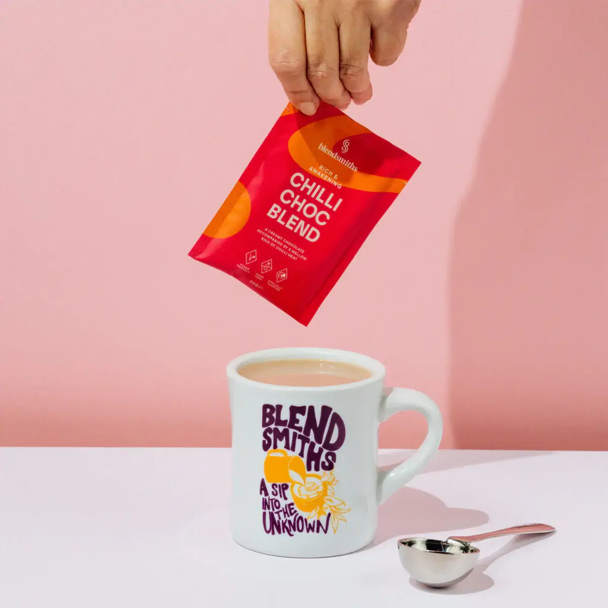 A colorful assortment of Blendsmiths drinking chocolate sachets, featuring Chilli Choc Blend, and more. Each sachet has a modern design with unique color schemes and highlights key attributes such as vegan-friendly and dairy-free.