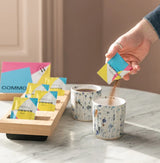 Instant Box featuring sachets of specialty instant coffee being added to cups for an effortless coffee experience.