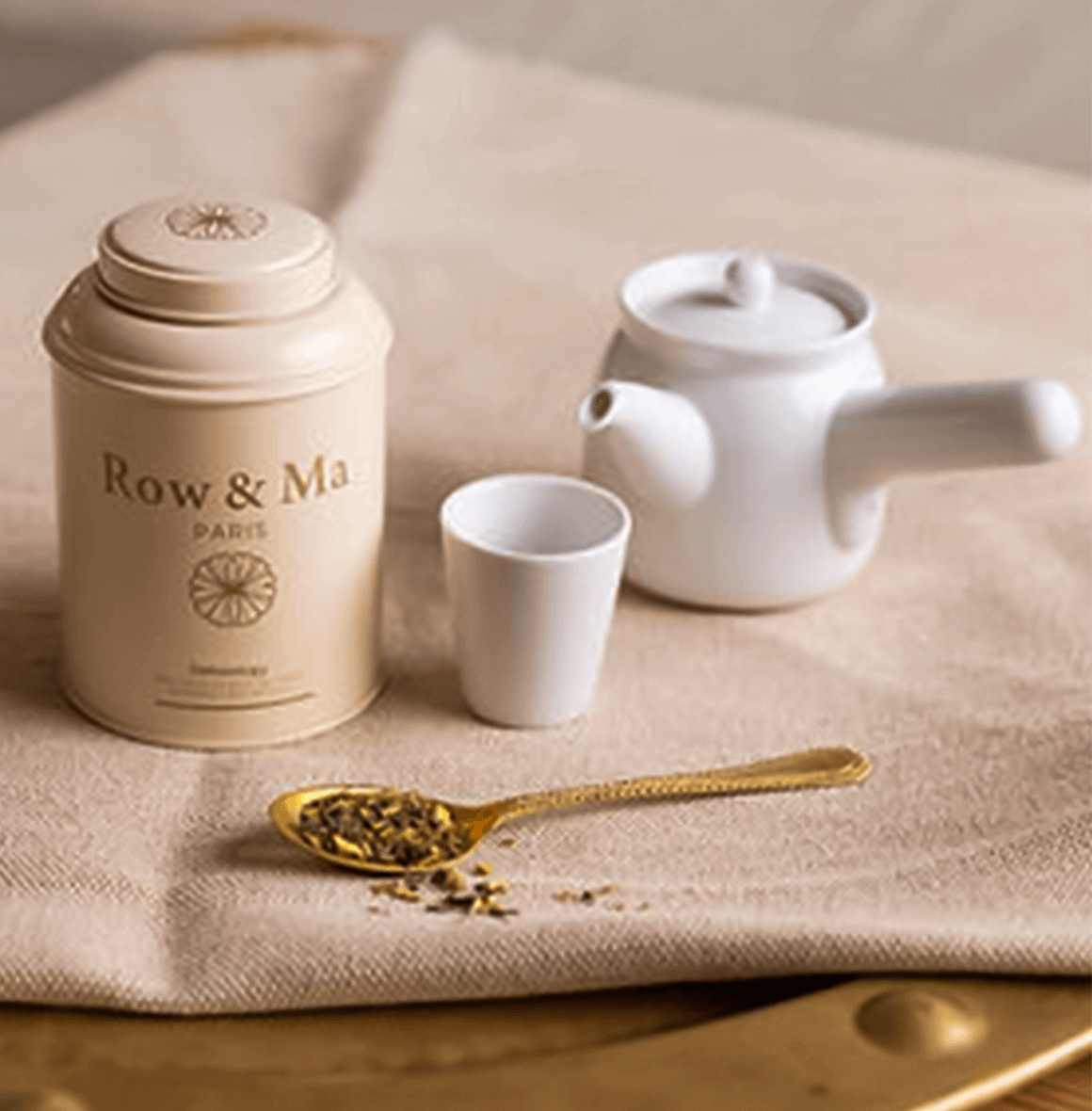 Elegant tea pot, cup, and herbal tea canister by Row & Ma, perfect for UAE gift hampers and drinkware collections.