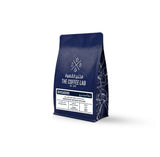 The Coffee Lab Divisadero specialty coffee beans in premium navy blue packaging with tasting notes of roasted hazelnut, wafer biscuit, toffee, and raisin.