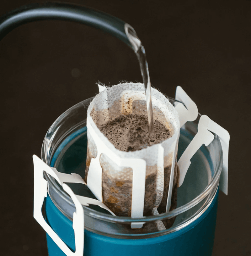 Brown Drip Kit Box by THREE Coffee includes 7 ready-to-brew medium-roast drip bags with caramel, nutty, and chocolate notes. Perfect for travel, office, or easy specialty coffee at home.