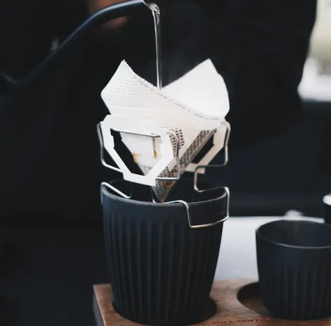 Premium drip bag coffee being brewed, showcasing smooth Colombian blend with zesty mandarin, perfect for unique flavor seekers.