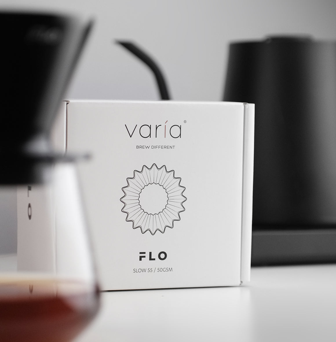 FLO 55 Paper Filters 100x packaging box with 'Slow 55 50GSM' label for quality coffee brewing.