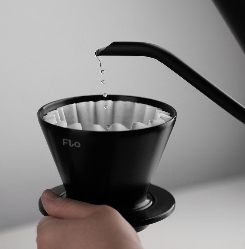 FLO 55 Paper Filters 100x in use, showcasing water dripping from a kettle into the filter.