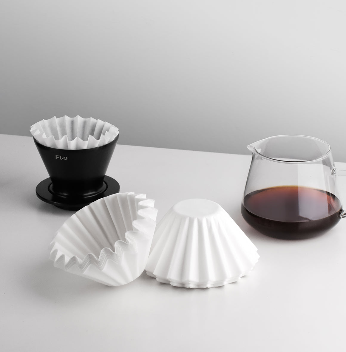 FLO 85 Paper Filters 100x with Varia FLO dripper and brewed coffee for optimal flavor.