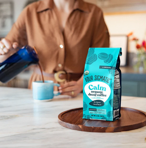 Calm Decaf Coffee by Four Sigmatic in cozy packaging, featuring Swiss Water Process decaf beans and organic Reishi, crafted to ease stress and support calming daily rituals.