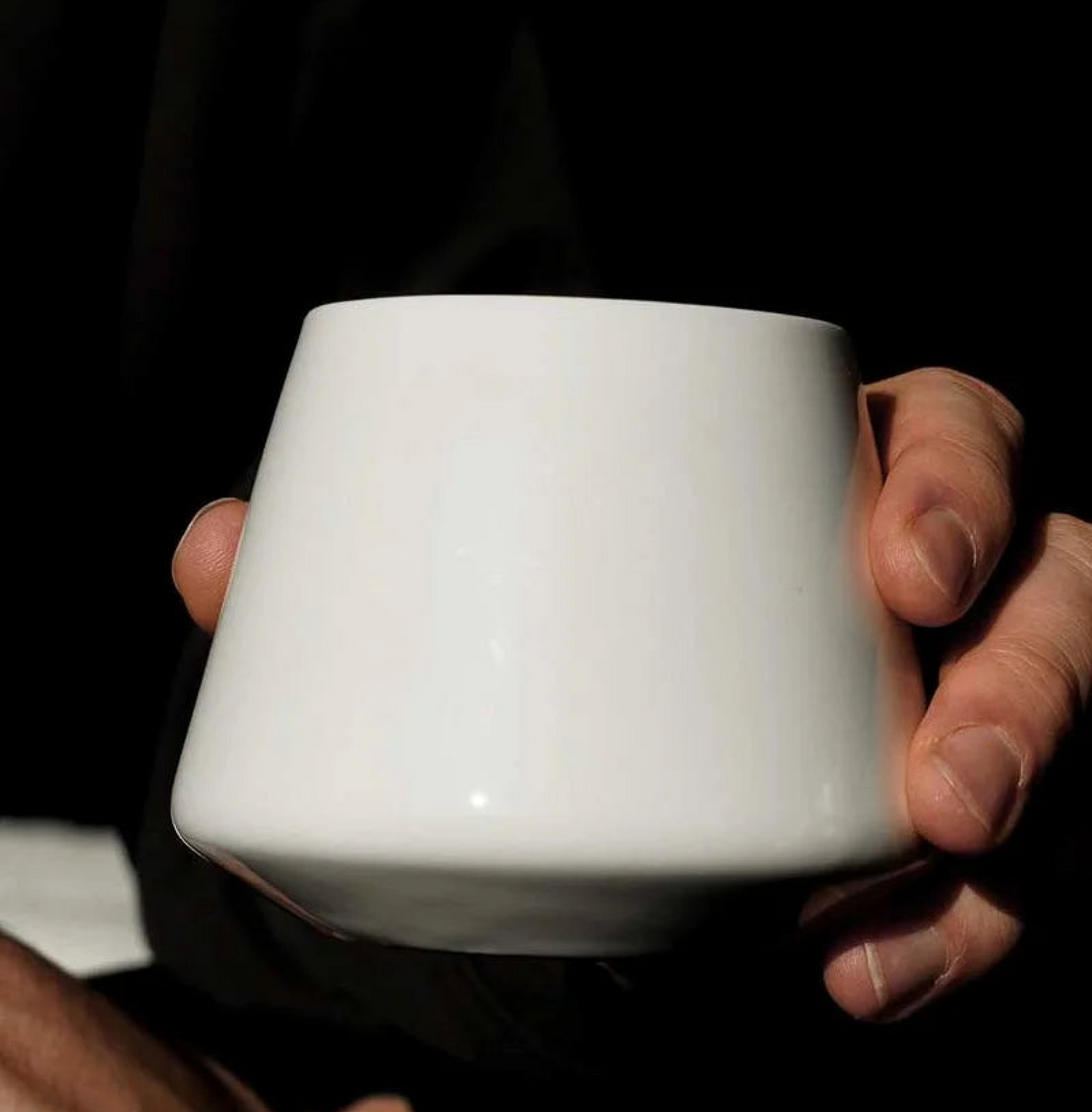 Hand holding Graycano Cupcano - Porcelain Small cup in natural light