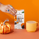 Pumpkin Spice Blend packaging with a small pumpkin and a mug of spiced drink against an orange background.