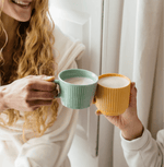Friends enjoying warm drinks with Pumpkin Spice Blend in colorful mugs, perfect for autumn comfort.