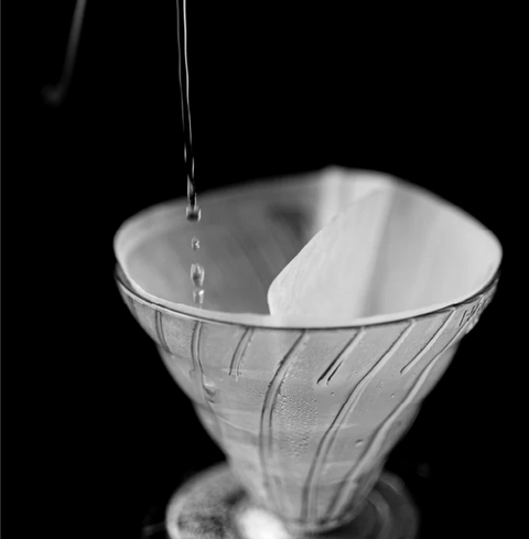 Sibarist Fast - Dual Chamber Specialty Coffee Filters in a conical dripper for pour-over brewing.