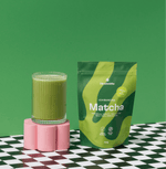 Bag of Ichibancha Ceremonial Matcha with a glass of matcha on a stylish surface, showcasing vibrant green color and packaging.