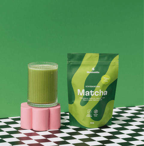 Bag of Ichibancha Ceremonial Matcha with a glass of matcha on a stylish surface, showcasing vibrant green color and packaging.