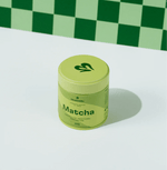 Container of Pure Ceremonial Grade Matcha on a green and white background