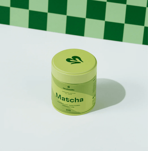 Container of Pure Ceremonial Grade Matcha on a green and white background