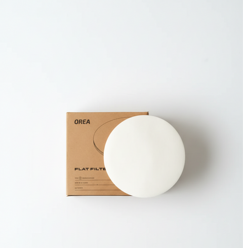 OREA Flat Filter Paper - Type G displayed on top of packaging for filter coffee brewing with precise extraction control.