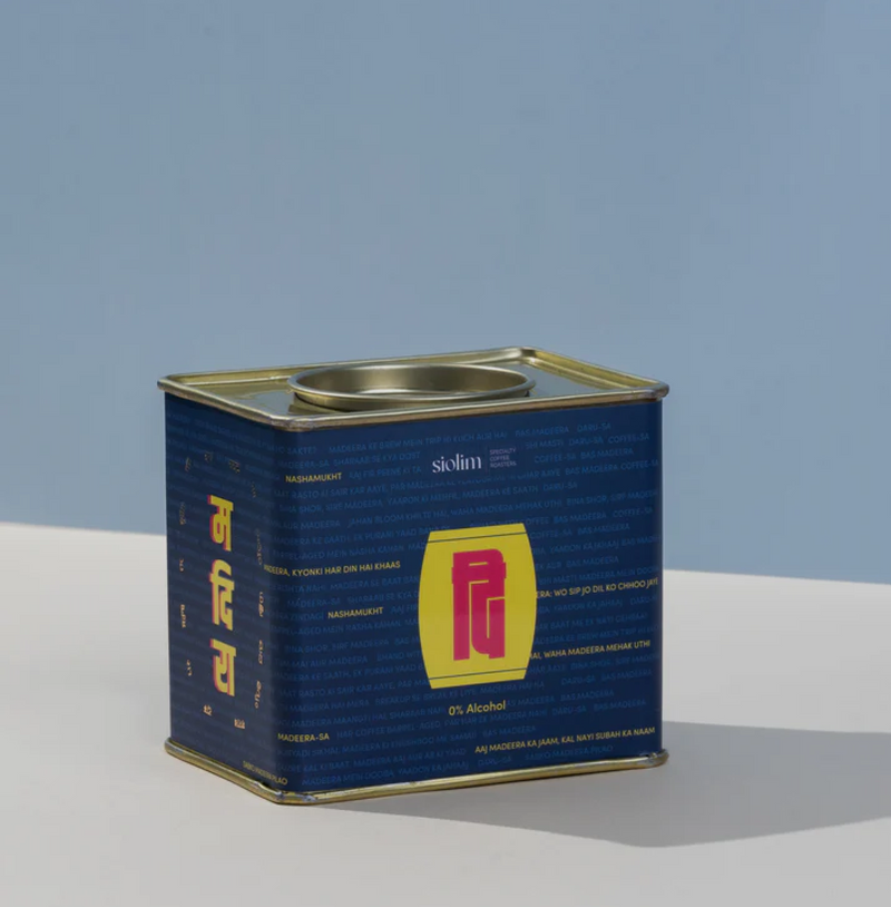 Tin of coffee labeled Barrel Aged Madeera by Siolim, featuring a rich and luxurious blend with chocolate-hazelnut notes.