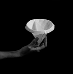 Hand holding Sibarist Fast - Dual Chamber Specialty Coffee Filters in black background