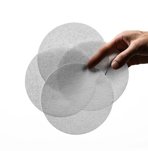 Hand holding OREA Flat Filter Paper - Type G for precise coffee extraction and even flow.