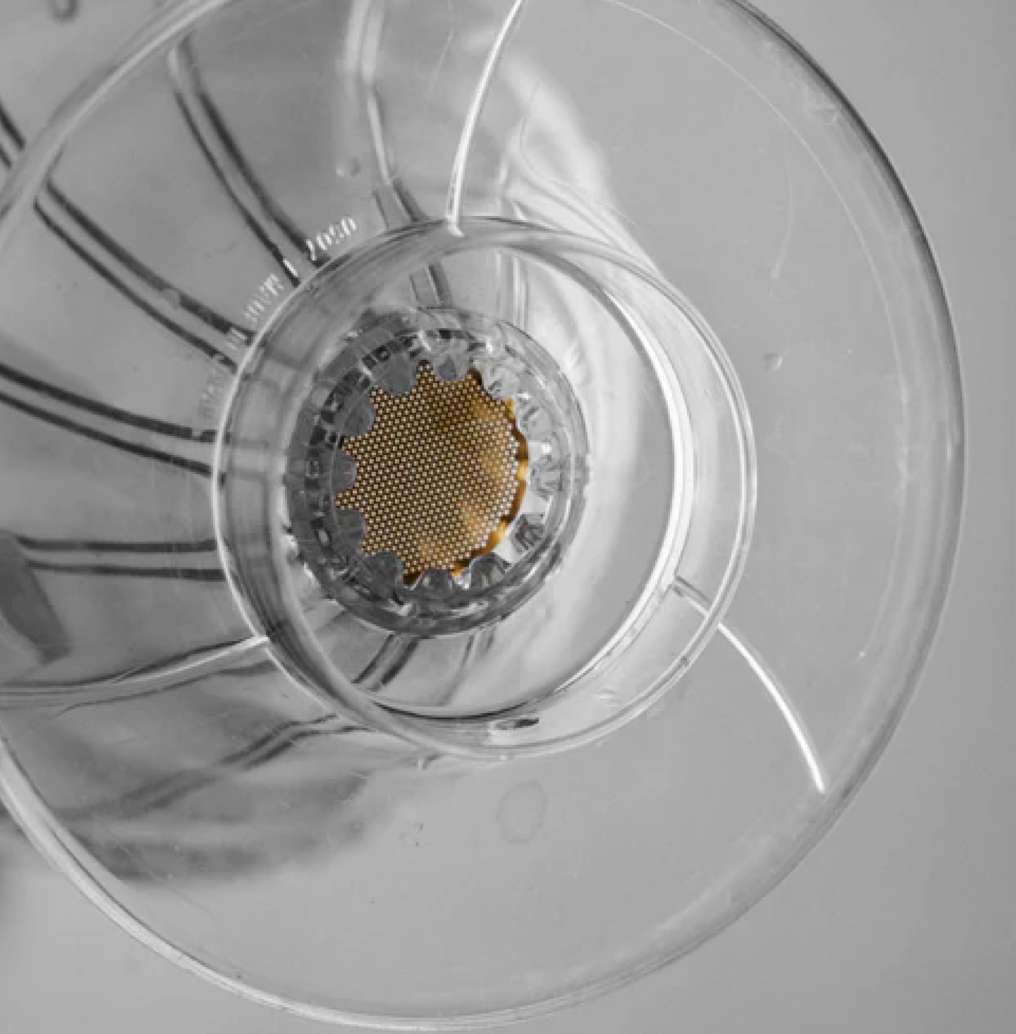 Close-up of the Sibarist Booster 22 precision-engineered mesh disc in a pour-over coffee maker, enhancing brewing with clarity.