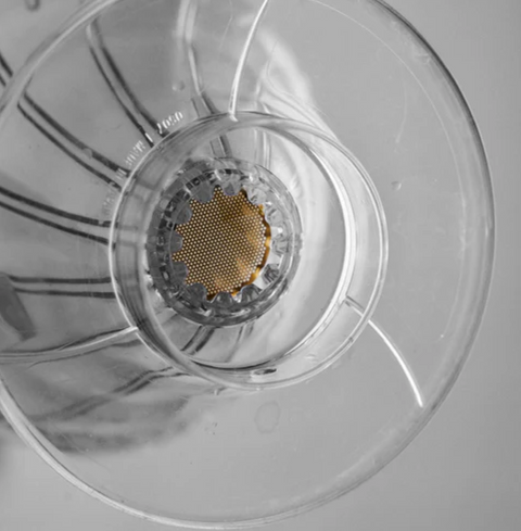 Close-up of the Sibarist Booster 22 precision-engineered mesh disc in a pour-over coffee maker, enhancing brewing with clarity.