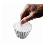 Hand holding OREA Wave Filter Paper for wave-style coffee brewing, enhances bright notes and maintains body.
