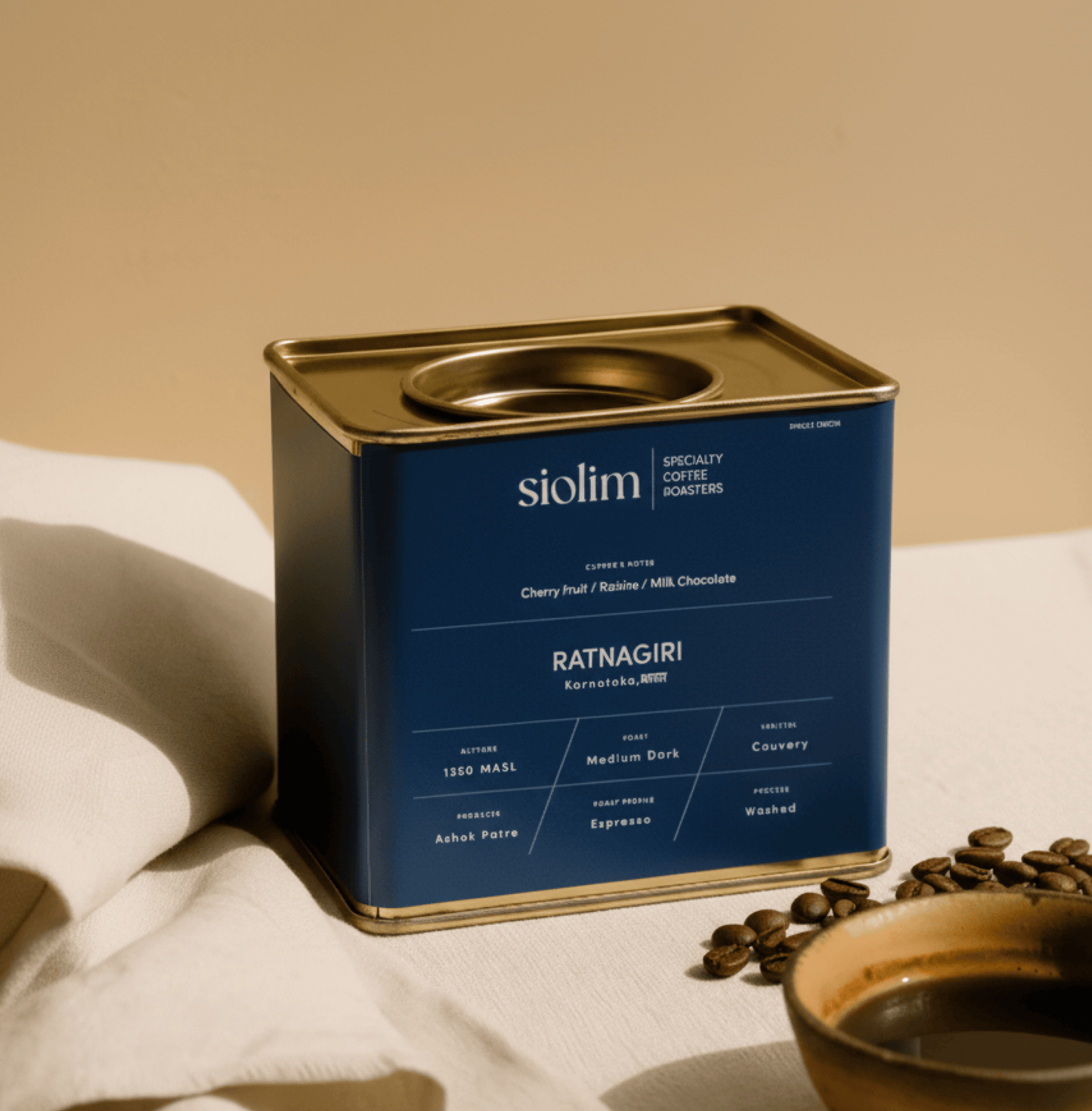 Ratnagiri Washed Single Origin coffee tin from Siolim Coffee on a table with coffee beans.