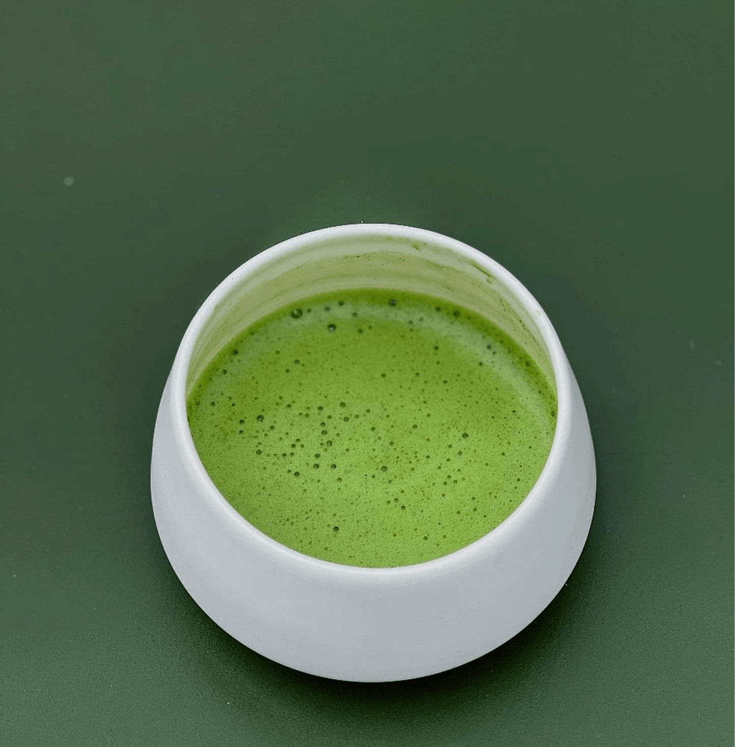 Ceramic cup of Uji Matcha with vibrant green color and rich foam