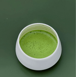 Ceramic cup of Uji Matcha with vibrant green color and rich foam