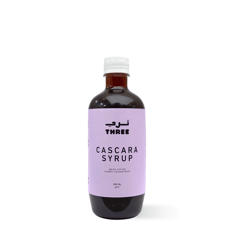 Bottle of organic Cascara Syrup ideal for summer drinks in UAE, made with purified water and cascara pods, on a plain background.