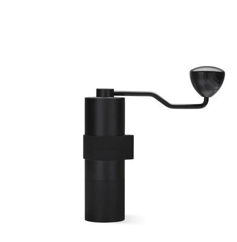 Normcore V2 Manual Coffee Grinder Titanium Plated with ergonomic silicone grip and sleek aluminum body.