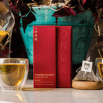 Oolong tea from Fujian, China, hand-rolled and infused with ginseng powder, offering a rich, lingering sweetness in the cup.