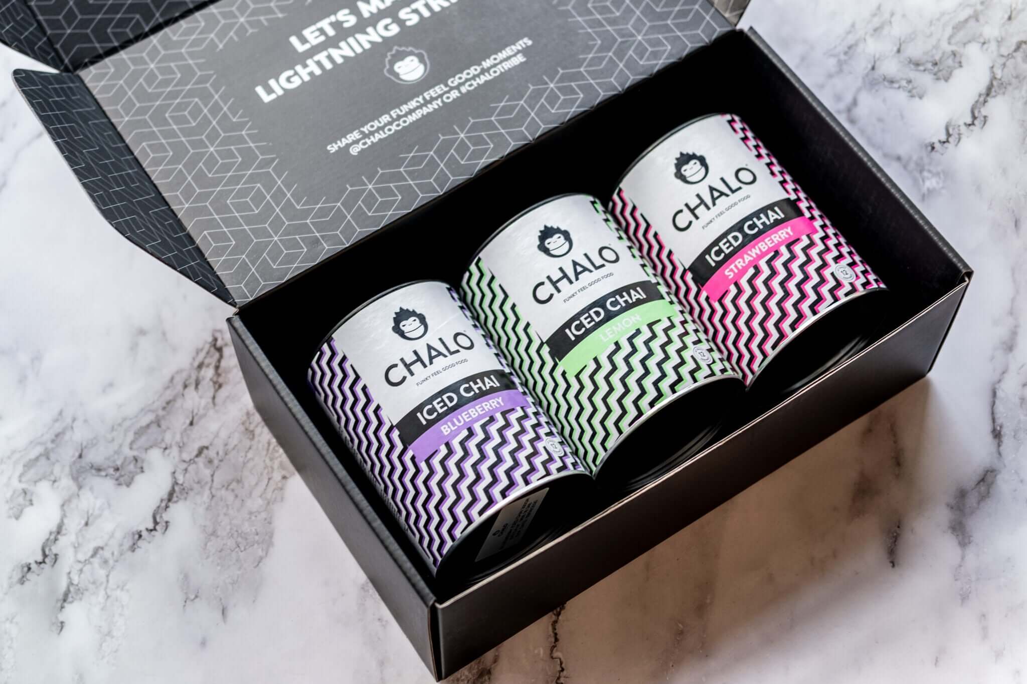 Four Chalo iced coffee cups in a box on a marble surface