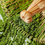 Close-up of bamboo whisk with Rare Matcha Gold No. 2, showcasing fine green powder from single harvest, single cultivar tea leaves.
